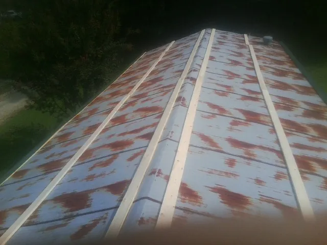 Rusted metal roof panels with new wood purlins before replacement — Storm Damage Roof Repair in Burlington by Roofing Brothers